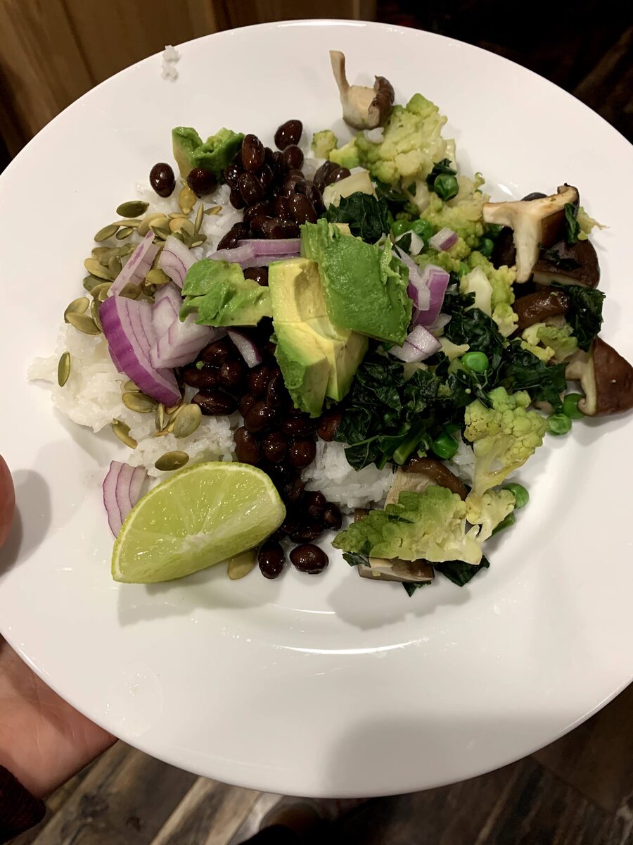 A salad with avocado, lime and greens