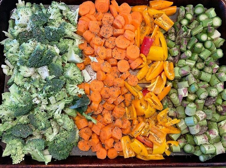 A tray of roasted broccoli, carrots and brussels sprouts
